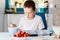 Child filling cupcakes form with dough ingredients