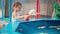 Child Fisher Catching Plastic Toy Fish On Pool Amusement Park Summer Day