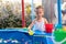 Child Fisher Catching Plastic Toy Fish On Pool Amusement Park Summer Day