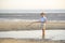 Child is fishing on the beach at the seaside