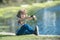 Child fishing at river or lake. Young kid fisher. Summer outdoor leisure activity. Little boy angling at river with rod.
