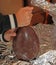 Child with a fist breaking the Easter egg made of chocolate