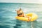 A Child floats on an inflatable circle at sea