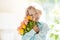 Child with flower bouquet. Mother day greeting