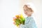 Child with flower bouquet. Mother day greeting