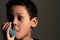 Child with flu with inhaler respiratory puff on grey background stock photo