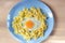 Child food. Funny food. Plate with pasta with fried egg in the form of funny face sun. Children`s menu and lunch concept. Flat