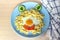 Child food. Funny food. Plate with pasta with fried egg and vegetables in the form of funny face. Children`s menu and lunch