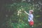 Child in forest picking berries