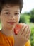 A child with a fruit. Kid eating fresh pear. Happy boy biting apple