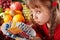 Child with fruit and vitamin pill.