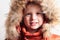 Child in fur hood and orange winter jacket. fashion kid.children.close-up