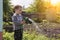 Child in the garden watering flowers