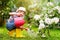 Child gardening. Boy with watering can in garden