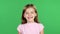 Child genuinely smile at the camera. Green screen