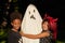 Child in ghost costume with friends