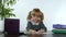 Child girl boss counting dollar cash bills. Baby businesswoman kid with money is sitting at office