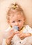 Child girl with bottle with infant formula at home