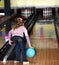Child girl in with bowling ball.