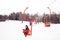 Child girl on a chair ski lift going uphill in the mountains in Bakuriani, Georgia