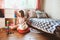 Child girl cleaning her room and organize wooden toys into knitted storage bag