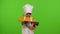 Child girl cook chef baker in apron and hat adding raisins to dough in bowl, preparing bread, cake