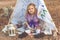 Child girl in decorative hovel on the nature