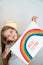 Child girl drew rainbow and poster stay home.