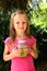 Child girl drinking healthy green vegetable smoothie - healthy eating, vegan, vegetarian, organic food and drink concept