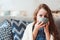 child girl drinking hot tea to recover from flu