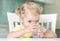 Child girl drinking water from glass closeup portrait