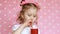 Child girl drinks a berry smoothie through a straw