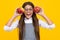 Child girl eating an apple over isolated yellow background. Tennager with fruit. Happy girl face, positive and smiling