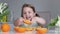 Child girl eating oranges. Vitamin nutrition.Caucasian toddler eats fruits.