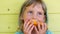 Child girl eats ripe mango