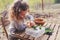 Child girl exploring nature in early spring forest. Kids learning to love nature. Teaching children about seasons changing.