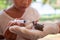 Child girl feeding water and food to baby sparrow bird with syringe