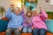 Child girl granddaughter grandfather grandmother using smartphone celebrating game win victory