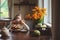 Child girl having breakfast at home in autumn morning. Real life cozy modern interior in country house