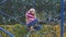 Child girl having fun on a playground of the small european village