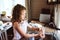 Child girl helps mother at home and wash dishes in kitchen