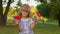 Child girl holding many colorful squishy silicone bubbles pop it popular sensory toys, thumb up