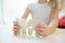 Child girl holding two big wooden puzzle pieces. Hands connecting jigsaw puzzle. Close up photo with small dof