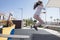 Child girl jumping from Walking the plank of playground pirate ship