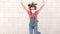 Child girl jumping wearing a protection mask against coronavirus