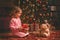 Child girl in nightgown with teddy bear in Christmas night