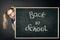 Child Girl Peek Out Behind School Blackboard with Chalk Drawing, Back to School, Happy Kid