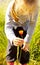 Child girl picking flower on a meadow