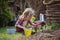 Child girl planting hyacinth flowers in spring garden