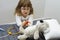 Child girl playing doctor with a toy. Rescuing of endangered animals